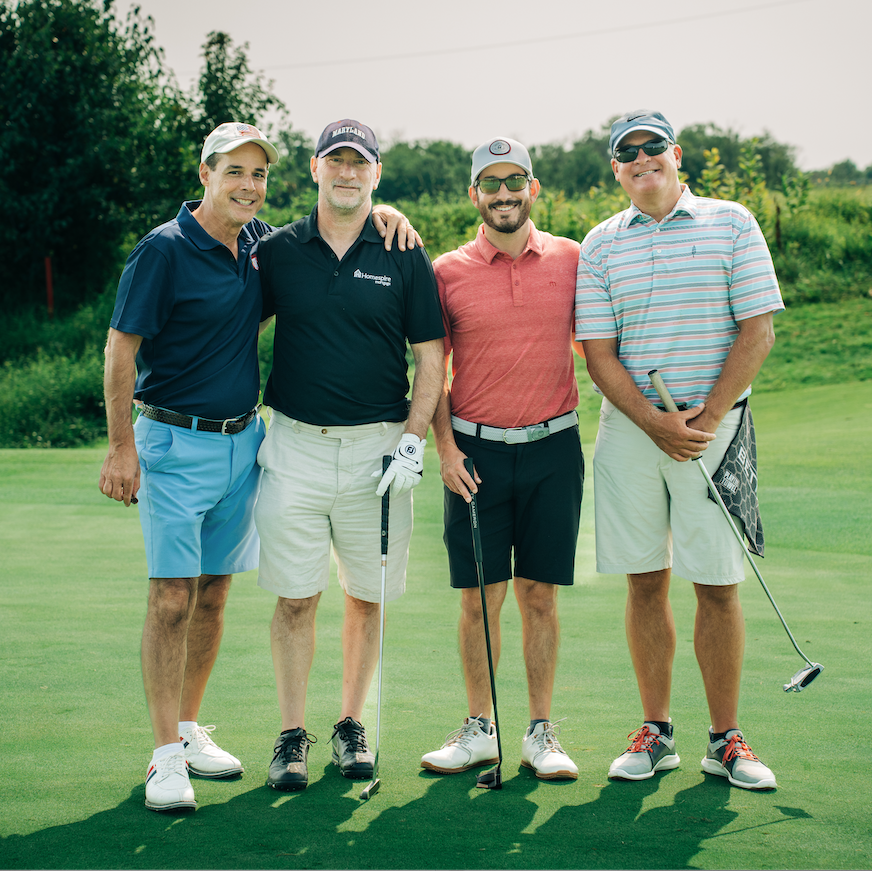 Charity classic 2022 group of golfers step-and-repeat pose