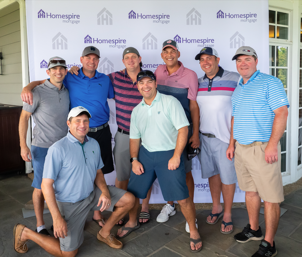 Charity classic 2022 group of golfers step-and-repeat pose